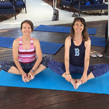 Two women doing yoga.