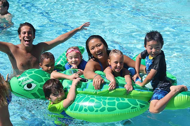 A group of kids having fun in the pool.