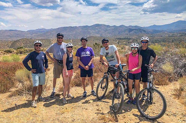 Group of mountain bikers on the peak of a mountain.